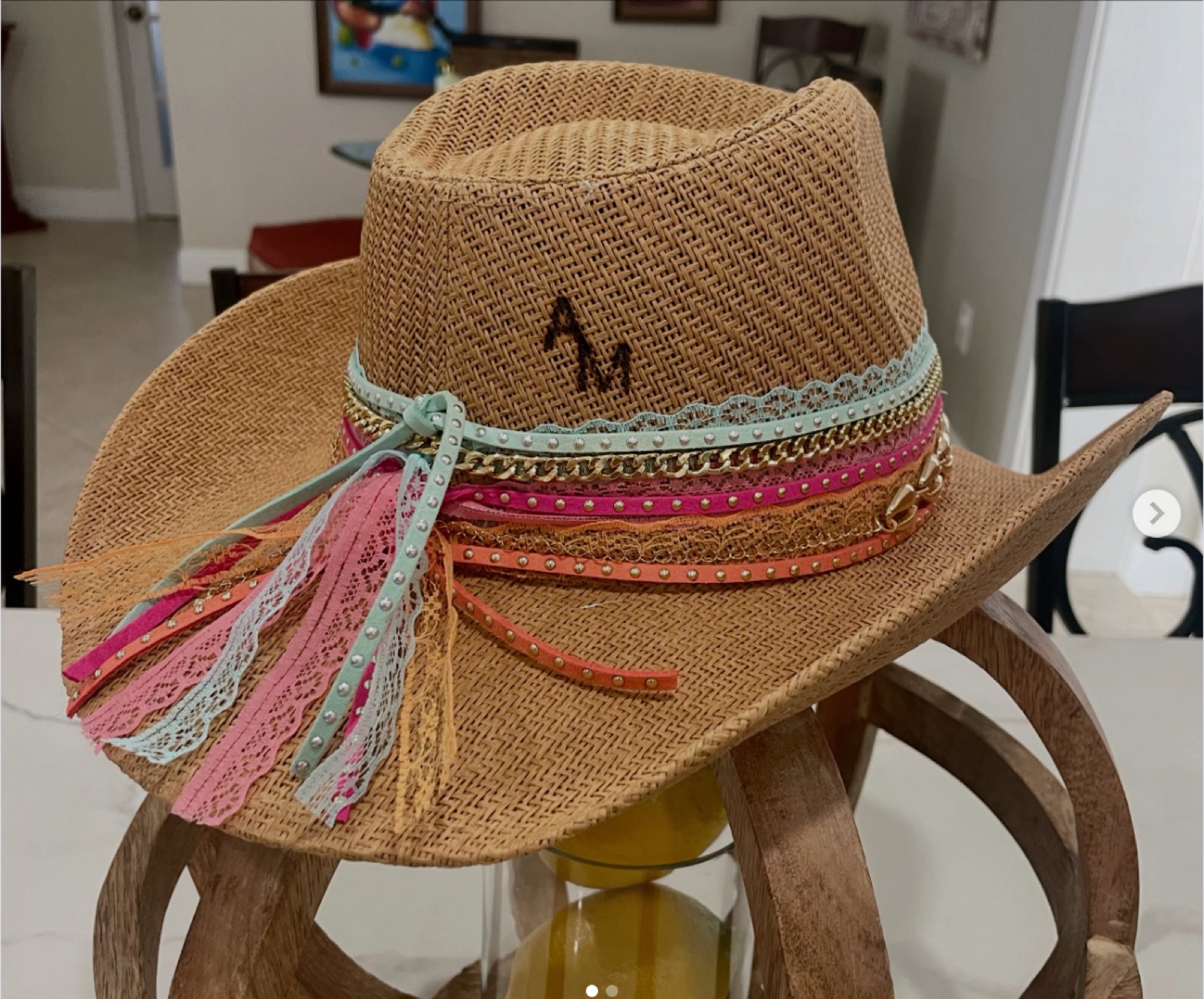 Straw hat with an embroidered monogram and lace tassel trim